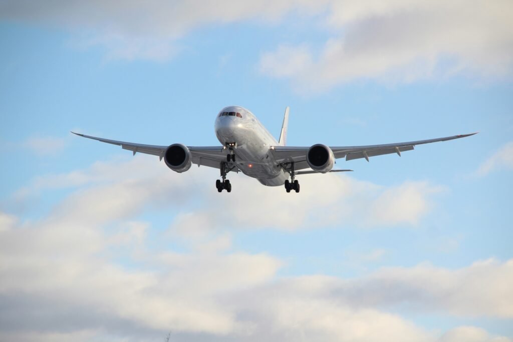 white passenger plane in mid air during daytime