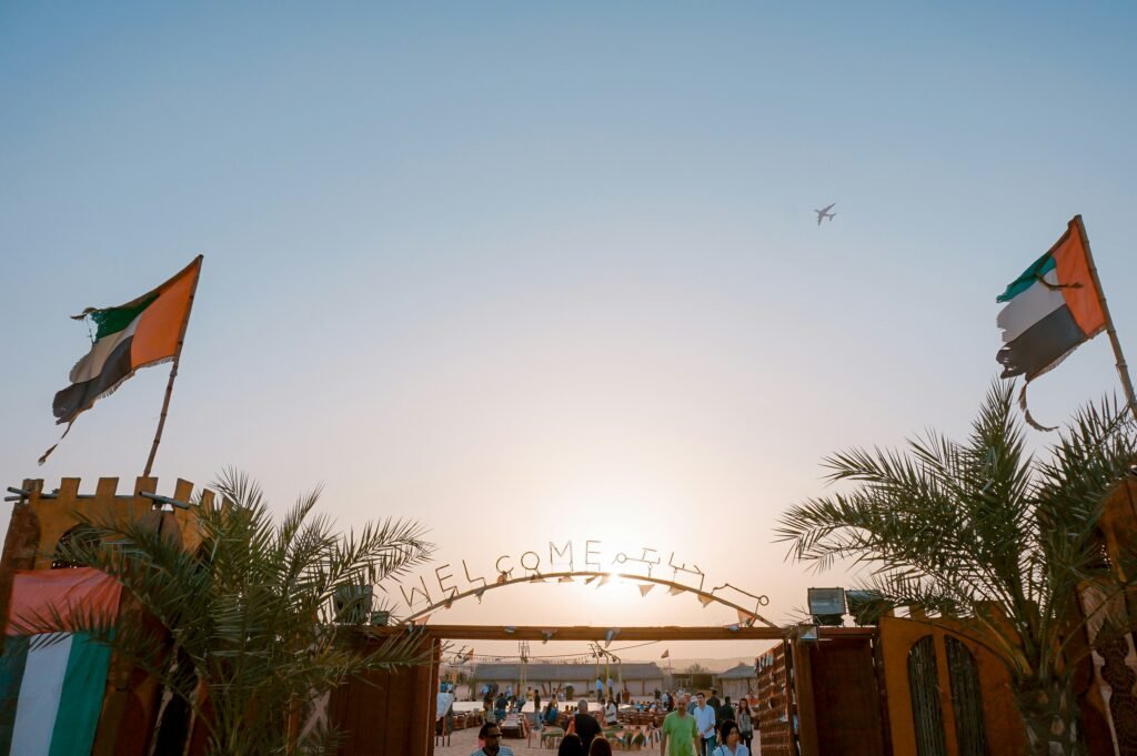 green palm trees besides Welcome arch